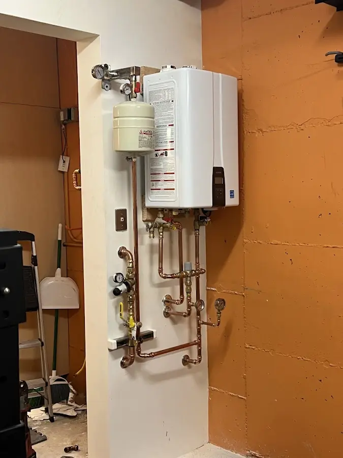 Plumbing technician inspecting water heater connections in Newburyport